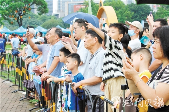 群众来到河边观赏这场“家门口”举办的龙舟盛事，现场热闹非凡。