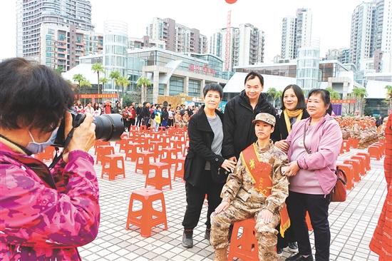入伍新兵出发前身着军装与家人合影留念。