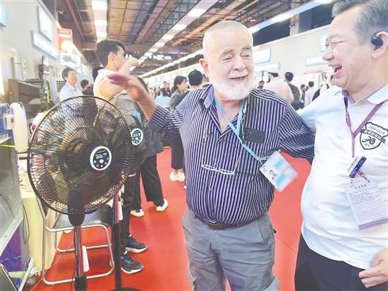 意大利客商Carlo（左）揽着路思拓总经理石秋（右）的肩膀，用带着意大利口音的英文向记者重复：“这是我的兄弟！”