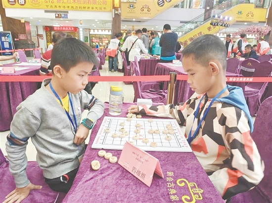 小棋手坐姿端正、神情专注。