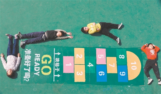 画完“跳格子”后,学生们兴奋地躺在地上合影。 画完“跳格子”后,学生们兴奋地躺在地上合影。