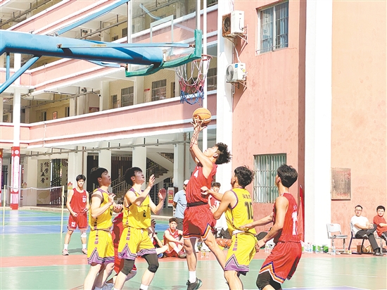 篮球场上，球员纵身投篮，队友与对手紧盯球路，赛事比拼正酣。