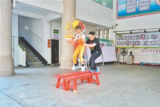 冯应毅带领学生练习移步、托举、跳跃等狮艺动作。